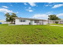 Charming single-story home features a well-manicured lawn and a welcoming front porch at 417 Glen Oak Rd, Venice, FL 34293