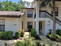 Inviting condo building exterior with well-maintained landscaping and visible unit numbers at 4835 Winslow Beacon # 46, Sarasota, FL 34235