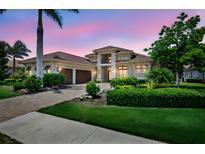 Stunning two-story home with well-manicured landscaping and a paved driveway at 4931 Benito Ct, Bradenton, FL 34211