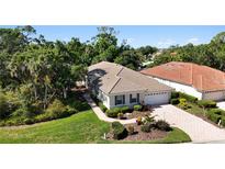 Beautiful single story home with lush landscaping and a paver driveway is nestled in a mature tree lined community at 5018 Hanging Moss Ln, Sarasota, FL 34238