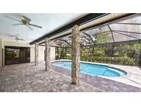 A lovely covered pool is surrounded by beautiful pavers and has direct access to the main house at 6107 Misty Oaks St, Sarasota, FL 34243