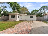 Charming single-story home with a brick driveway and a well-manicured lawn at 8075 48Th N Ave, St Petersburg, FL 33709