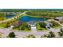 An aerial view of a home in a community with ponds and lush landscaping on an expansive lot at 826 Honeyflower Loop, Bradenton, FL 34212