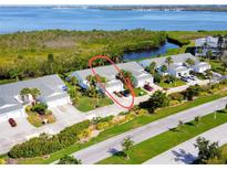 A beautiful townhouse community with lush landscaping and waterfront views on a sunny day at 967 Waterside Ln # 1, Bradenton, FL 34209