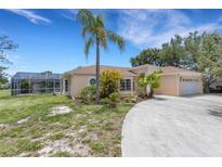 Charming single-story home with lush landscaping and a screened-in pool enclosure at 1026 Graham Rd, Venice, FL 34293