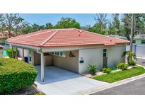 Charming home featuring a red tile roof, well-maintained landscaping, and a convenient covered carport at 139 Vista Hermosa Circle, Sarasota, FL 34242