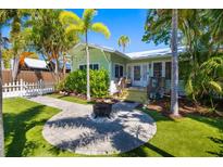 Charming cottage with inviting backyard, fire pit, and lush lawn, perfect for outdoor enjoyment at 1871 Prospect St, Sarasota, FL 34239