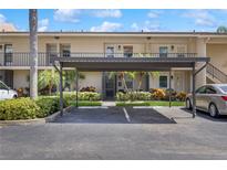 Charming condo building featuring assigned covered parking and well-maintained landscaping at 2639 Woodgate Ln # H8, Sarasota, FL 34231