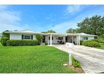 Charming single-story home featuring a well-manicured lawn and covered carport at 3276 Westford Ln, #117,, Sarasota, FL 34231