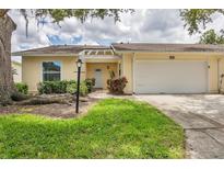 Charming single-story home with a well-manicured lawn and attached two-car garage at 4131 Oakhurst W Cir # 3133, Sarasota, FL 34233