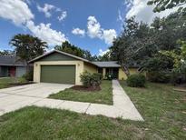 Charming single-story home with a well-maintained lawn, mature trees, and attached two-car garage at 5032 81St Avenue E Ter, Sarasota, FL 34243