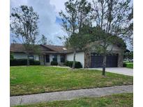 Charming single-story home with well-maintained lawn and a stone-accented garage at 5213 20Th Street E Ct, Bradenton, FL 34203