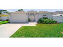 Charming single-story home featuring a well-maintained lawn and an attached two-car garage at 5410 Matthew Ct, Sarasota, FL 34231