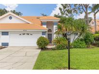 Charming single-Gathering home featuring a tile roof, well-manicured lawn, and beautiful landscaping at 6755 Approach Rd # 31, Sarasota, FL 34238
