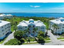 Stunning aerial view of a waterfront condo complex, surrounded by lush greenery and offering beautiful water views at 7820 34Th W Ave # 102, Bradenton, FL 34209