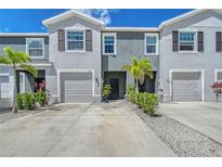 Inviting townhome exterior featuring well-maintained landscaping and attached garages at 8557 Milestone Dr, Sarasota, FL 34238