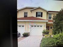 Charming two-story home featuring a red roof, a dual garage, and lovely landscaping at 1209 Jonah Dr, North Port, FL 34289