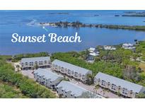 Aerial view of complex with beach access to tranquil waters at 1500 Sunset Rd # B4, Tarpon Springs, FL 34689