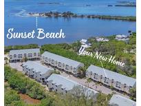 Beautiful aerial view of coastal condo community and sunset beach with blue waters in the background at 1500 Sunset Rd # B4, Tarpon Springs, FL 34689