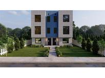 Modern two-story townhome with a blue central accent, black windows, and landscaped front yard at 2146 5Th N Ave, St Petersburg, FL 33713