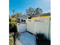 Cozy patio area featuring a white privacy fence, gate, and concrete walkway at 2607 29Th W Ave, Bradenton, FL 34205