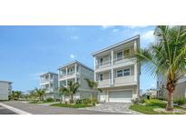 Charming multi-story townhouse with gray brick driveway and multiple balconies in a sunny setting at 4322 Marina View Way, Cortez, FL 34215