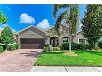 Charming single-Gathering home features a well-maintained lawn, mature palm tree, and a two-car garage at 5307 65Th E Ter, Ellenton, FL 34222