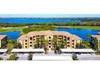 Spacious condo complex overlooks a golf course, ponds, and bay, with covered parking for residents and visitors at 6509 Grand Estuary Trl # 201, Bradenton, FL 34212