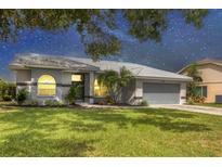 Charming single-story home featuring a well-maintained lawn and inviting curb appeal with beautiful landscaping at 6929 Stetson Street Cir, Sarasota, FL 34243