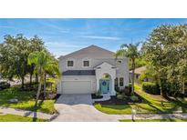 Charming two-story home featuring a beautiful front yard with lush landscaping and a welcoming entrance at 8804 Founders Cir, Palmetto, FL 34221
