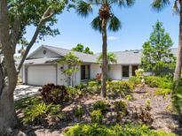 Charming single-story home featuring a lush landscaped front yard and a bright exterior at 1684 Pintail Way, Sarasota, FL 34231