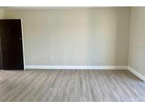 Spacious living room featuring wood-look flooring and neutral paint at 2636 Hidden Lake N Dr # G, Sarasota, FL 34237