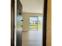 Bright living room with wood flooring, and a sliding glass door leading to an outdoor view at 2636 Hidden Lake N Dr # G, Sarasota, FL 34237