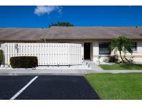 Charming villa featuring a well-maintained lawn, partial privacy fence, and convenient parking at 2904 64Th W St # 2904, Bradenton, FL 34209