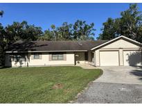 Charming one-story home featuring an attached two car garage, manicured lawn, and neutral paint scheme at 3804 65Th E St, Bradenton, FL 34208