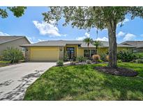 Well-maintained, single-story home featuring beautiful landscaping and a two-car garage at 4733 Spring Meadow Ln, Sarasota, FL 34233
