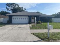 Charming single-story home with a well-manicured lawn, white garage door, and inviting front entrance at 5848 Milton Ave, Sarasota, FL 34243