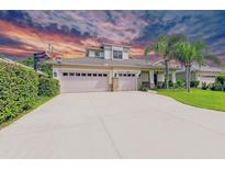 Charming single-Gathering home featuring a three-car garage, manicured lawn, and lush landscaping at 6423 Royal Tern Cir, Lakewood Ranch, FL 34202