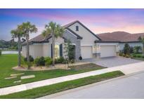Charming single-Gathering home with a tile roof, stone accents, a three-car garage, and lush landscaping at 7228 Great Egret Blvd, Sarasota, FL 34241