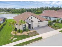 Beautiful single-Gathering home with a 3-car garage, stone accents, tile roof, and well manicured lawn at 7228 Great Egret Blvd, Sarasota, FL 34241