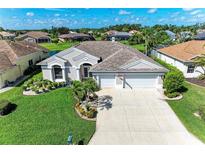 Charming single-story home with a well-manicured lawn and three-car garage at 11915 Oak Ridge Dr, Parrish, FL 34219