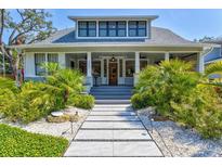 Charming two-story home with landscaped yard and inviting front porch at 1523 1St W Ave, Bradenton, FL 34205