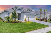 Beautiful single-Gathering home featuring a well-manicured lawn, fresh landscaping, and charming exterior lighting at 15813 San Lazzaro Ave, Bradenton, FL 34211