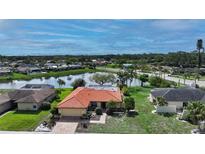 Beautiful single-Gathering home boasting a tile roof and lovely pond view, perfect for serene living at 1677 Fleetwood Dr, Sarasota, FL 34232