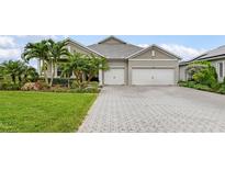 Charming single-story home featuring a two-car garage, well-manicured lawn and tropical landscaping at 17204 Bullhorn Cir, Punta Gorda, FL 33982
