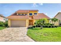 Charming two-story home featuring a well-maintained yard, barrel tile roof, and a spacious driveway at 175 Inlets Blvd # 175, Nokomis, FL 34275