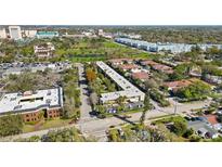 An aerial view shows the property nestled in a vibrant community with lush greenery and convenient parking at 2155 Wood St # A26, Sarasota, FL 34237