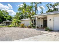 Charming single-story home with mature landscaping and a welcoming entrance, located in a desirable neighborhood at 2866 E Rainbow Cir, Sarasota, FL 34231
