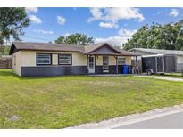 Charming single-story home with a well-maintained lawn and inviting front porch at 3211 Deerfield Dr, Tampa, FL 33619
