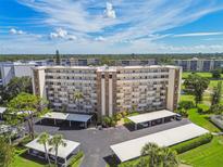 Exterior shot of building with balconies and covered parking on a sunny day at 3680 Ironwood Circle # 704-L, Bradenton, FL 34209